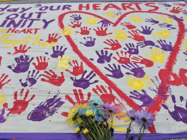 A makeshift memorial with flowers and handprints rests in a parking lot near the Pulse nightclub in Orlando, Fla.